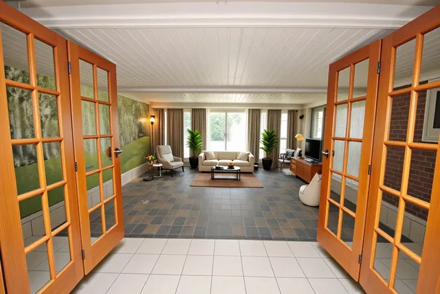 a view of a patio with table and chairs and potted plants
