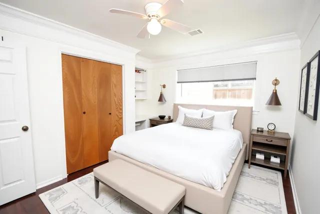 an empty room with wooden floor and a window