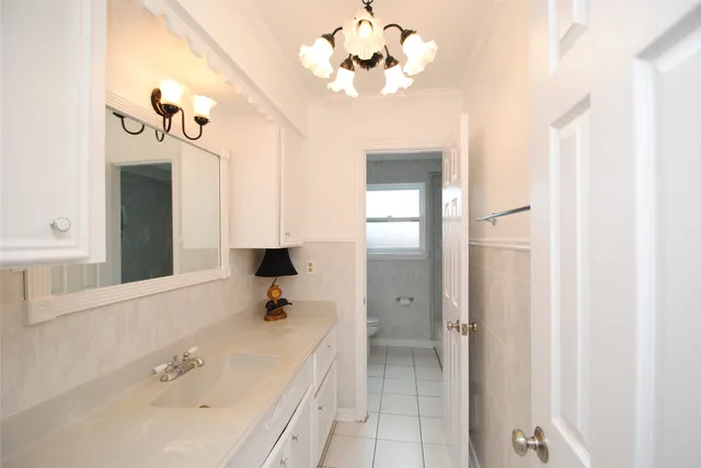 a white toilet sitting next to a window