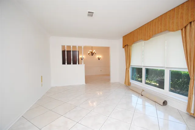 a view of a big room with windows and entryway