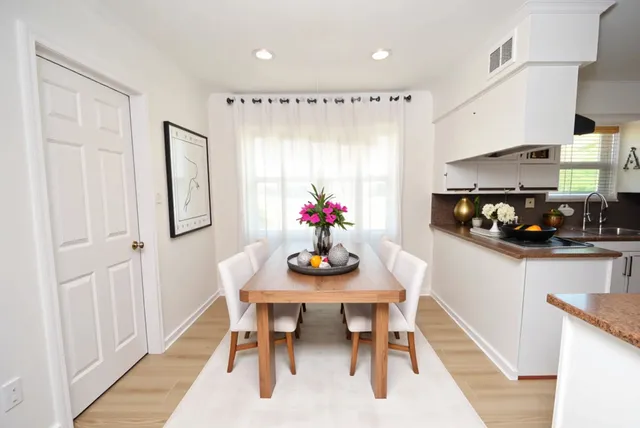 a view of a dining room with furniture kitchen and chandelier
