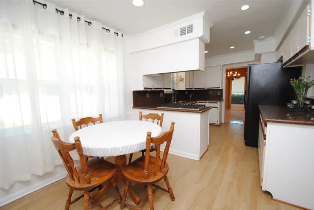 a kitchen with stainless steel appliances kitchen island granite countertop a sink and a refrigerator
