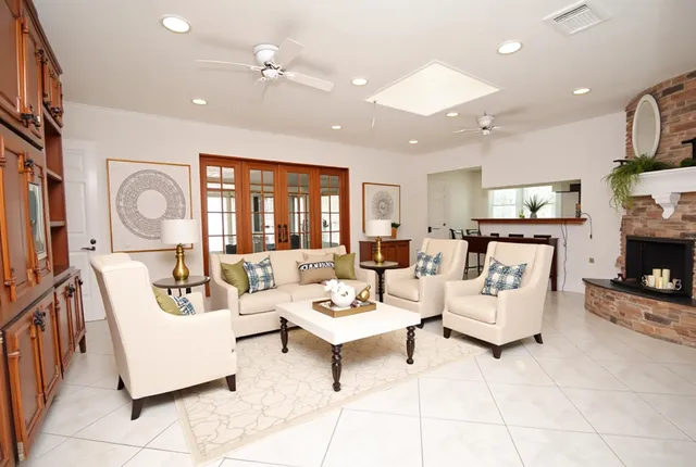a living room with furniture fireplace and a flat screen tv