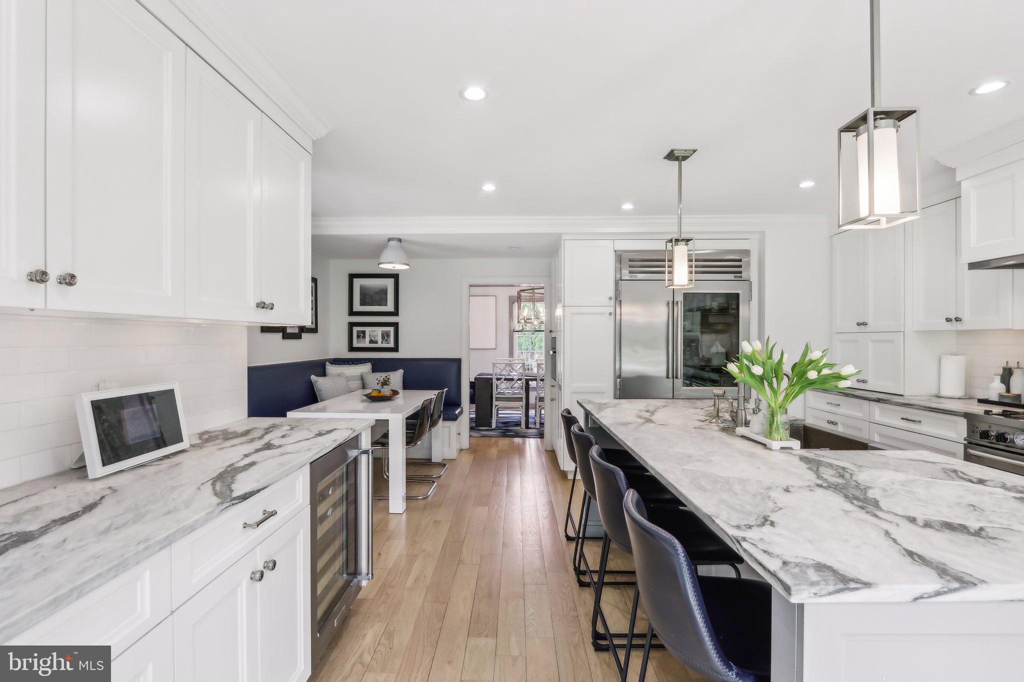 410 North Valley Forge Road Devon, PA 19333 - Photo 15 of 84 a kitchen with stainless steel appliances granite countertop a stove a sink a oven a dining table and chairs with wooden floor