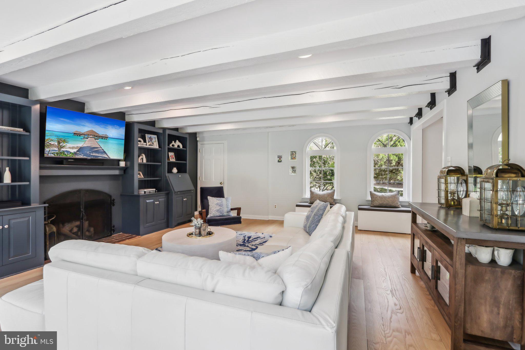 410 North Valley Forge Road Devon, PA 19333 - Photo 25 of 84 a living room with furniture a fireplace and a flat screen tv