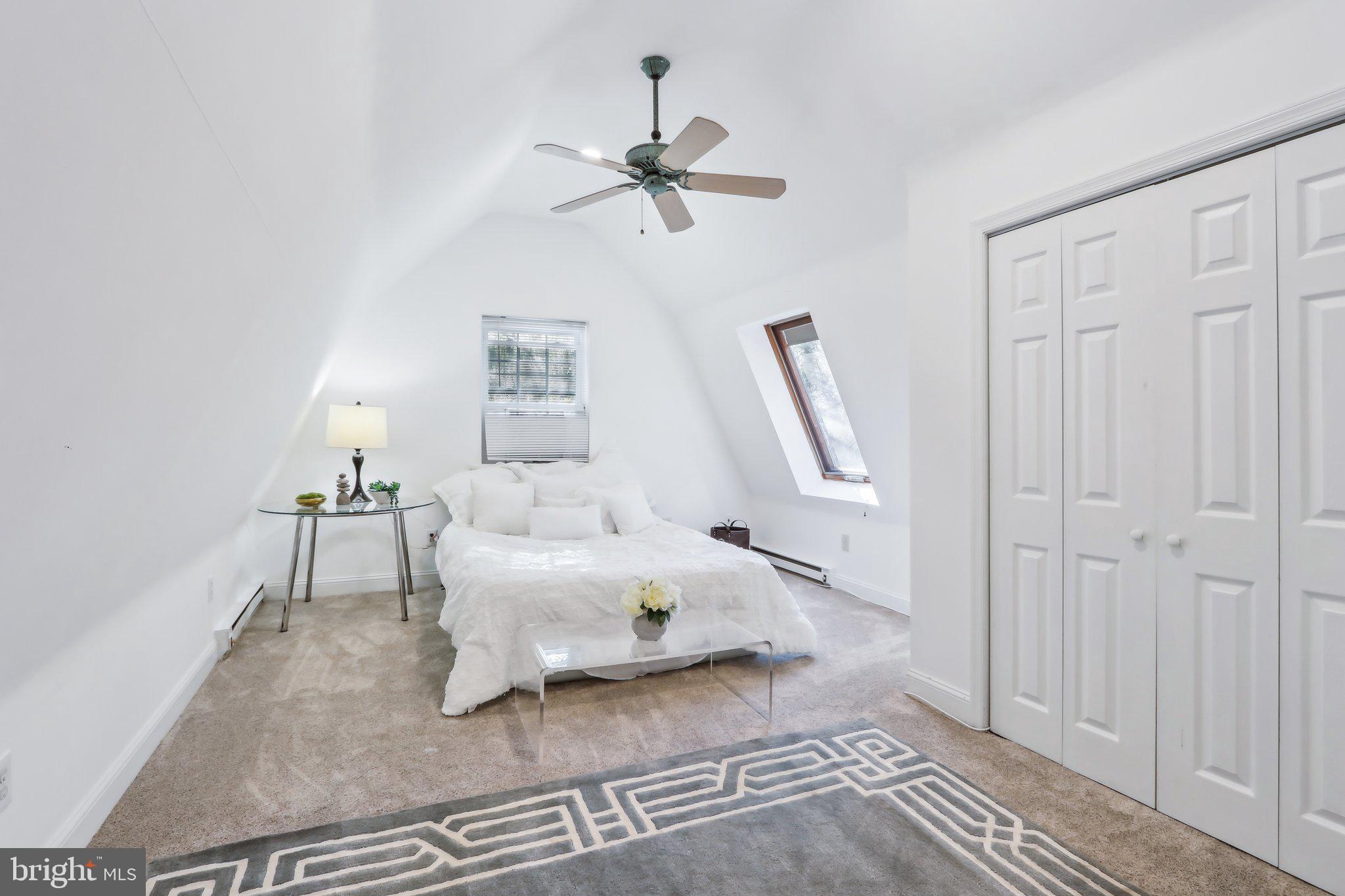 410 North Valley Forge Road Devon, PA 19333 - Photo 70 of 84 a bedroom with a bed and a chandelier