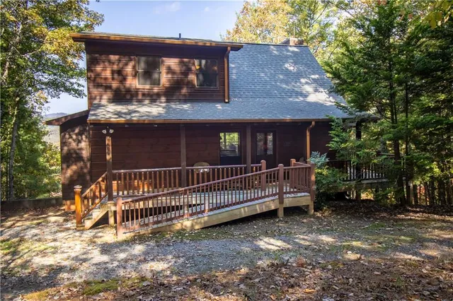 a view of a house with a bed and a yard
