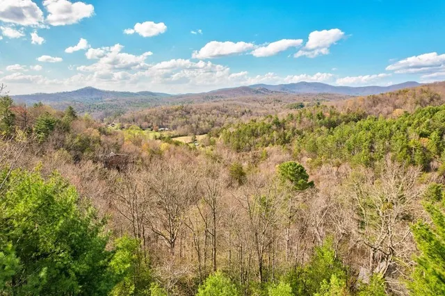 a living room with lots of furniture and a large window
