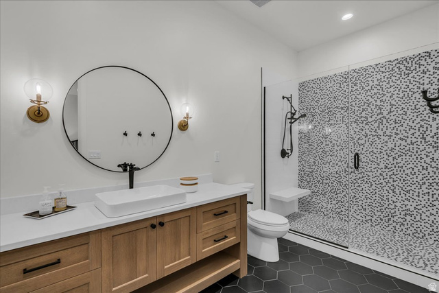 2608 Canyon Ridge Drive St. George, UT 84770 - Photo 69 of 86 Bathroom featuring a wood-finish vanity with quartz countertop, vessel sink, and matte black fixtures