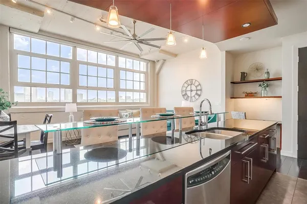 a kitchen with granite countertop a sink stove and cabinets
