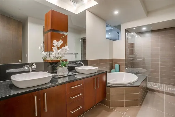 a bathroom with a tub sink and mirror