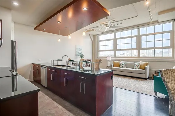 a kitchen with counter top space a sink and stainless steel appliances