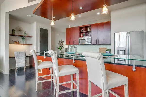 a kitchen with stainless steel appliances granite countertop a stove microwave and cabinets