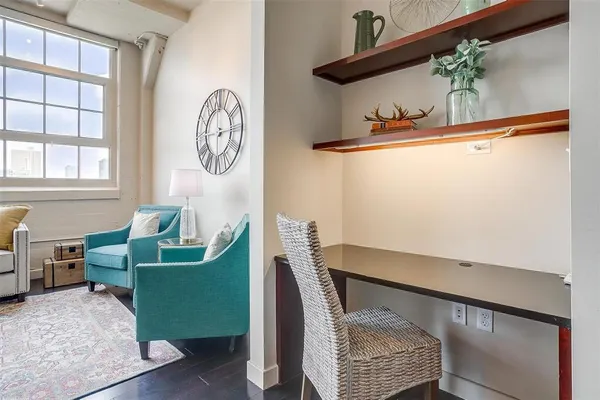 a living room with furniture a large window and a table