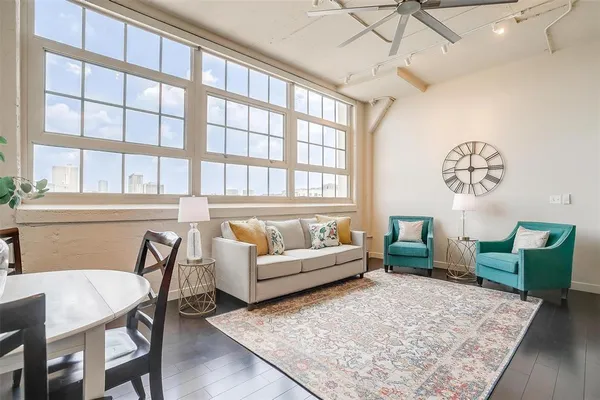 a living room with furniture wooden floor and a table