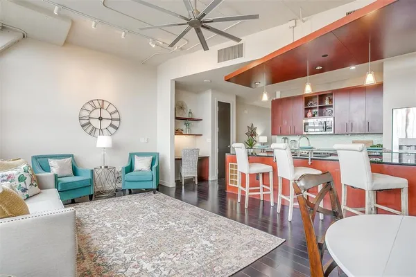 a living room with stainless steel appliances kitchen island granite countertop furniture and a kitchen view