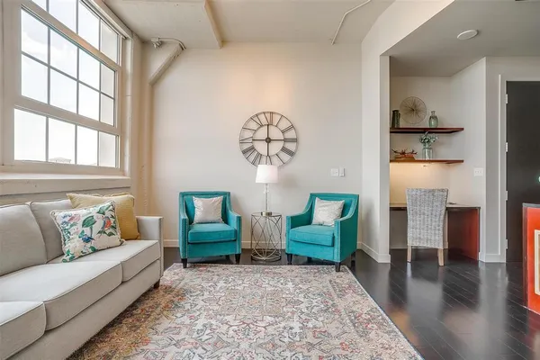a living room with furniture wooden floor and a table