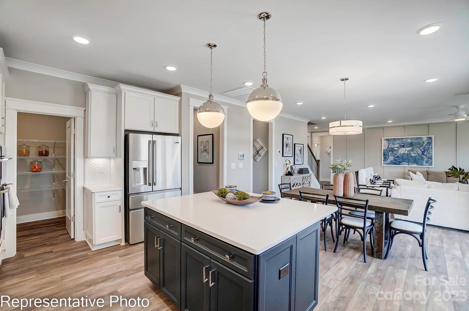 4185 Roberta Road Harrisburg, NC 28075 - Photo 13 of 48 a kitchen with a stove a refrigerator a sink and chairs