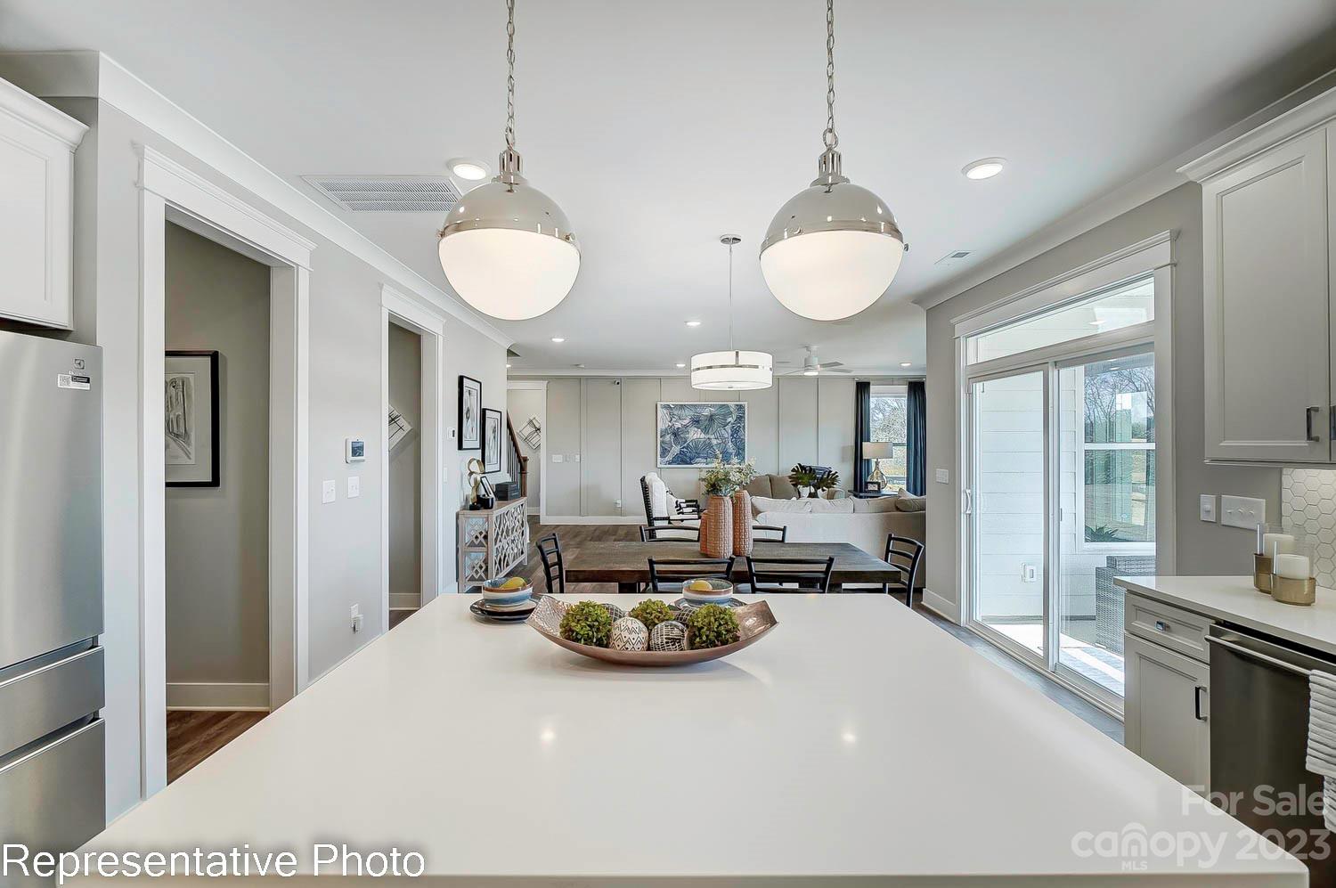 4185 Roberta Road Harrisburg, NC 28075 - Photo 15 of 48 a view of a room with kitchen island stainless steel appliances furniture a large window and kitchen view