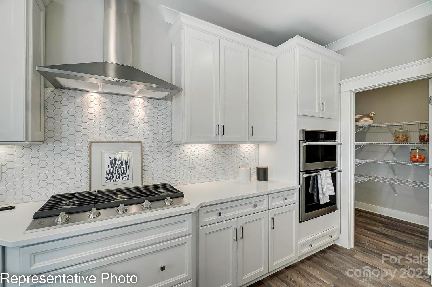 4185 Roberta Road Harrisburg, NC 28075 - Photo 16 of 48 a kitchen with white cabinets and white appliances