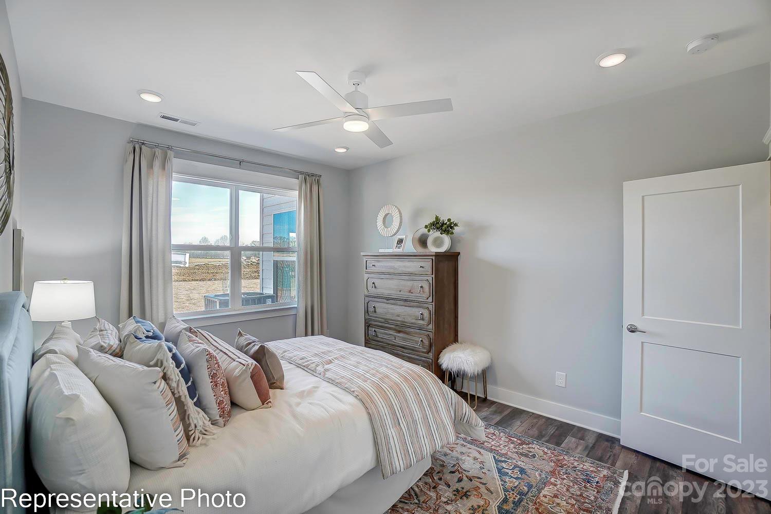 4185 Roberta Road Harrisburg, NC 28075 - Photo 25 of 48 a bedroom with a bed and a chandelier