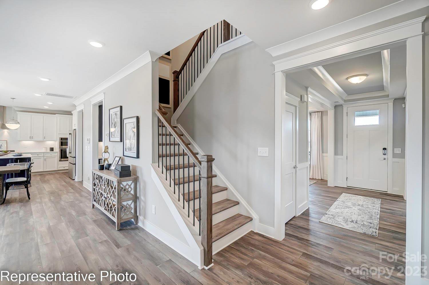 4185 Roberta Road Harrisburg, NC 28075 - Photo 28 of 48 a view of a hallway with wooden floor and staircase
