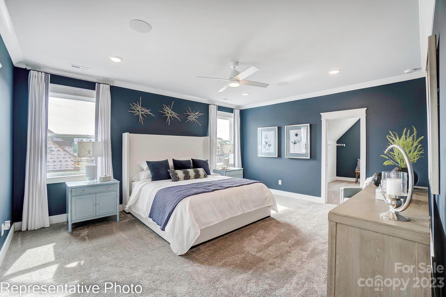 4185 Roberta Road Harrisburg, NC 28075 - Photo 29 of 48 a spacious bedroom with a large bed and a chandelier