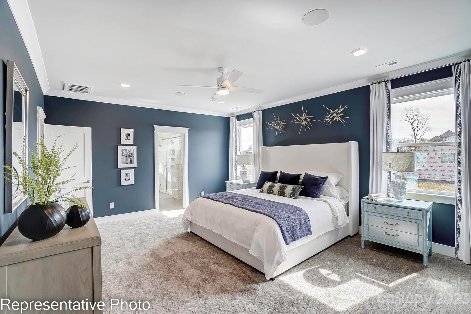 4185 Roberta Road Harrisburg, NC 28075 - Photo 30 of 48 a bedroom with a large bed and a large window