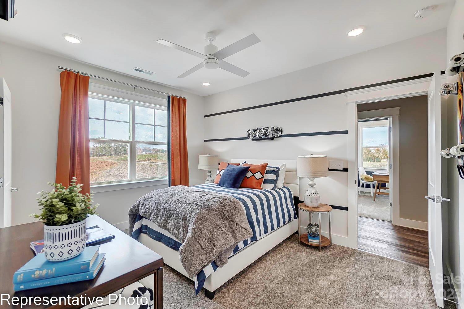 4185 Roberta Road Harrisburg, NC 28075 - Photo 36 of 48 a bedroom with a bed and a chandelier