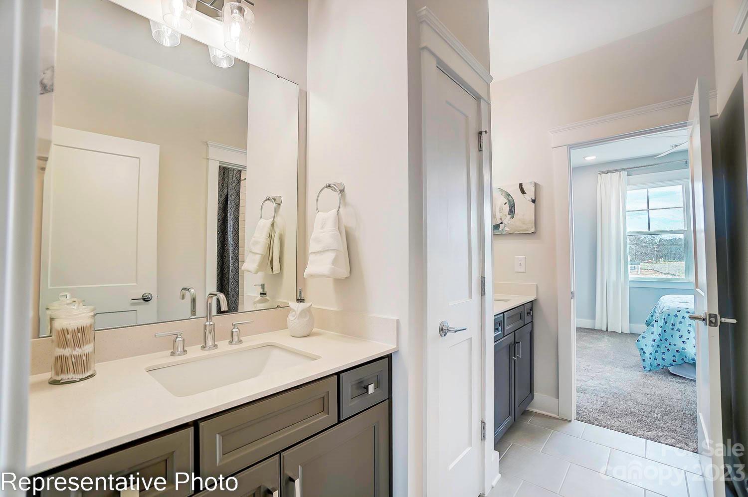4185 Roberta Road Harrisburg, NC 28075 - Photo 40 of 48 a en suite bathroom with a sink and a mirror