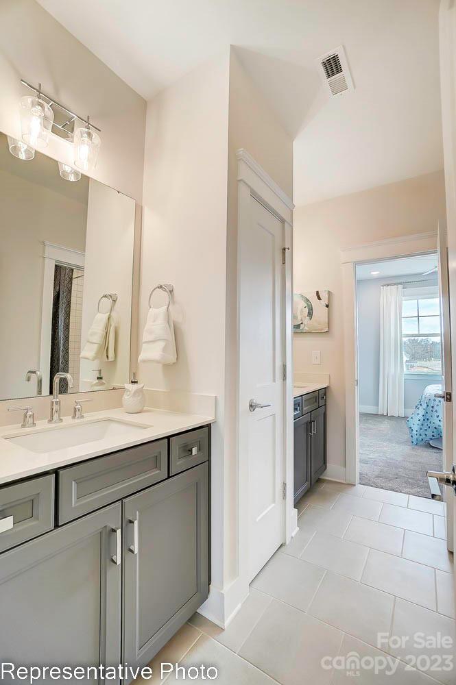 4185 Roberta Road Harrisburg, NC 28075 - Photo 41 of 48 a bathroom with a sink and a mirror