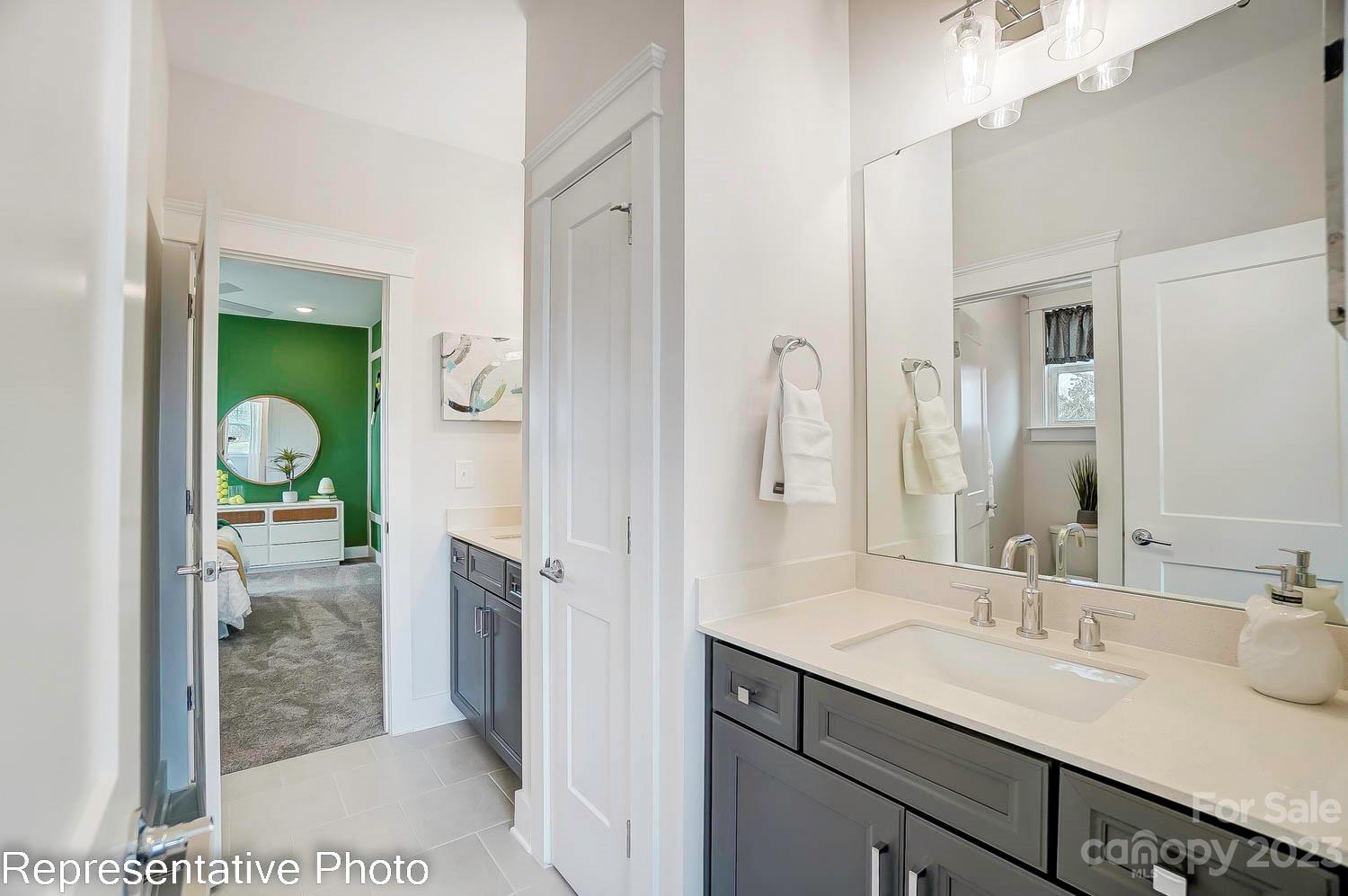 4185 Roberta Road Harrisburg, NC 28075 - Photo 42 of 48 a spacious bathroom with a granite countertop sink mirror and a shower
