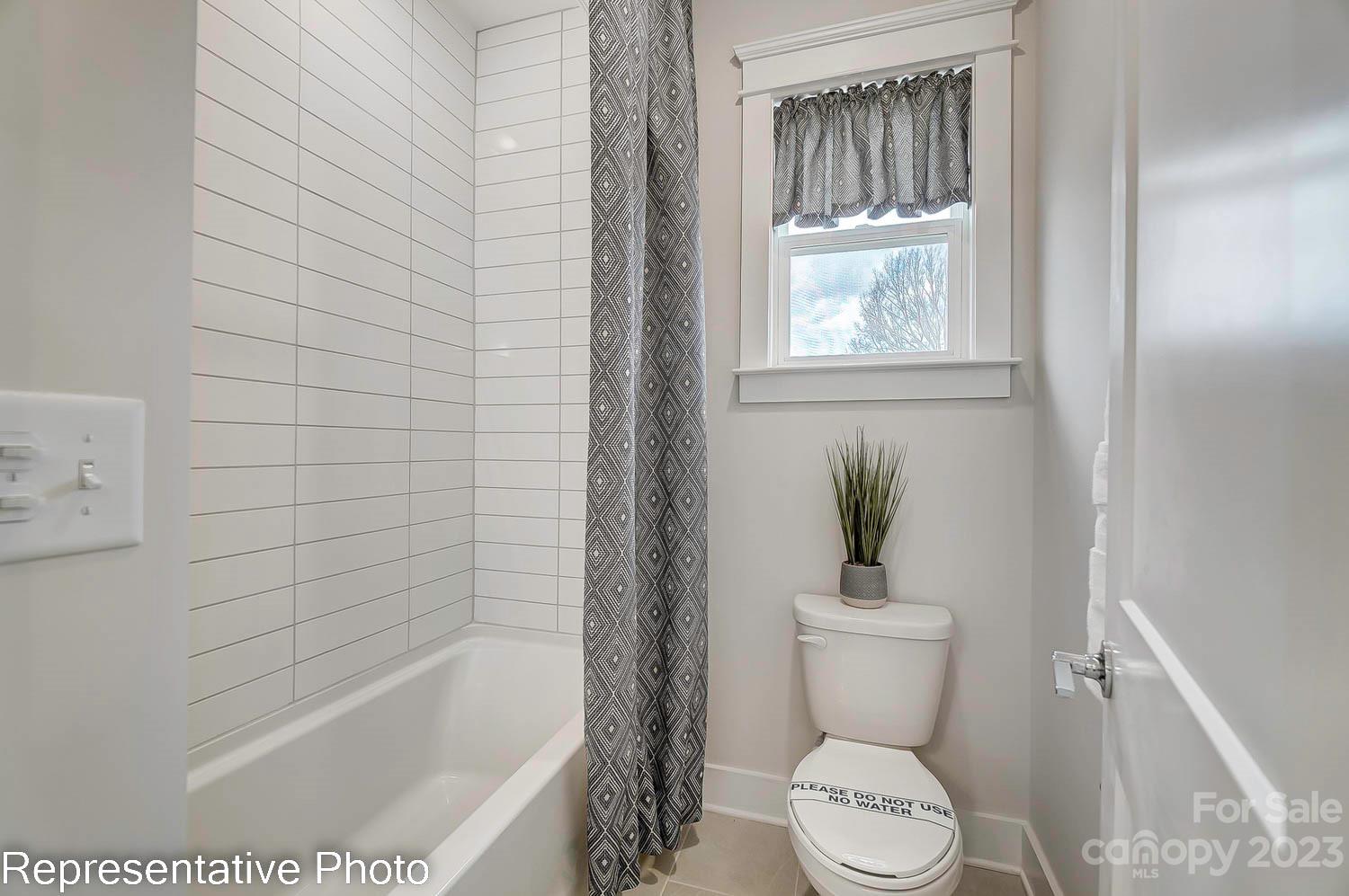 4185 Roberta Road Harrisburg, NC 28075 - Photo 43 of 48 a white toilet sitting next to a bath tub