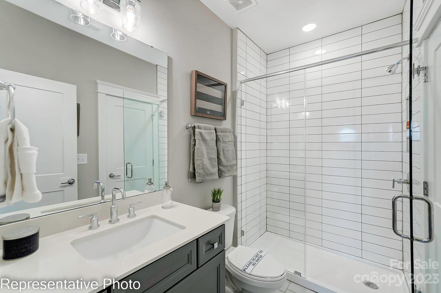 4185 Roberta Road Harrisburg, NC 28075 - Photo 45 of 48 a bathroom with a sink toilet and shower