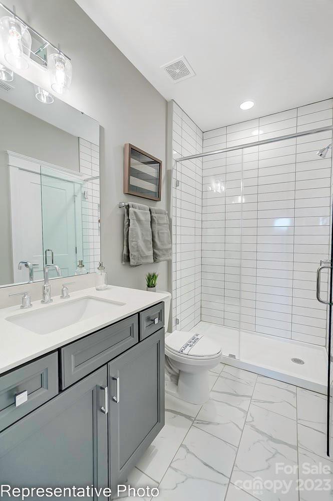 4185 Roberta Road Harrisburg, NC 28075 - Photo 46 of 48 a bathroom with a sink toilet and shower