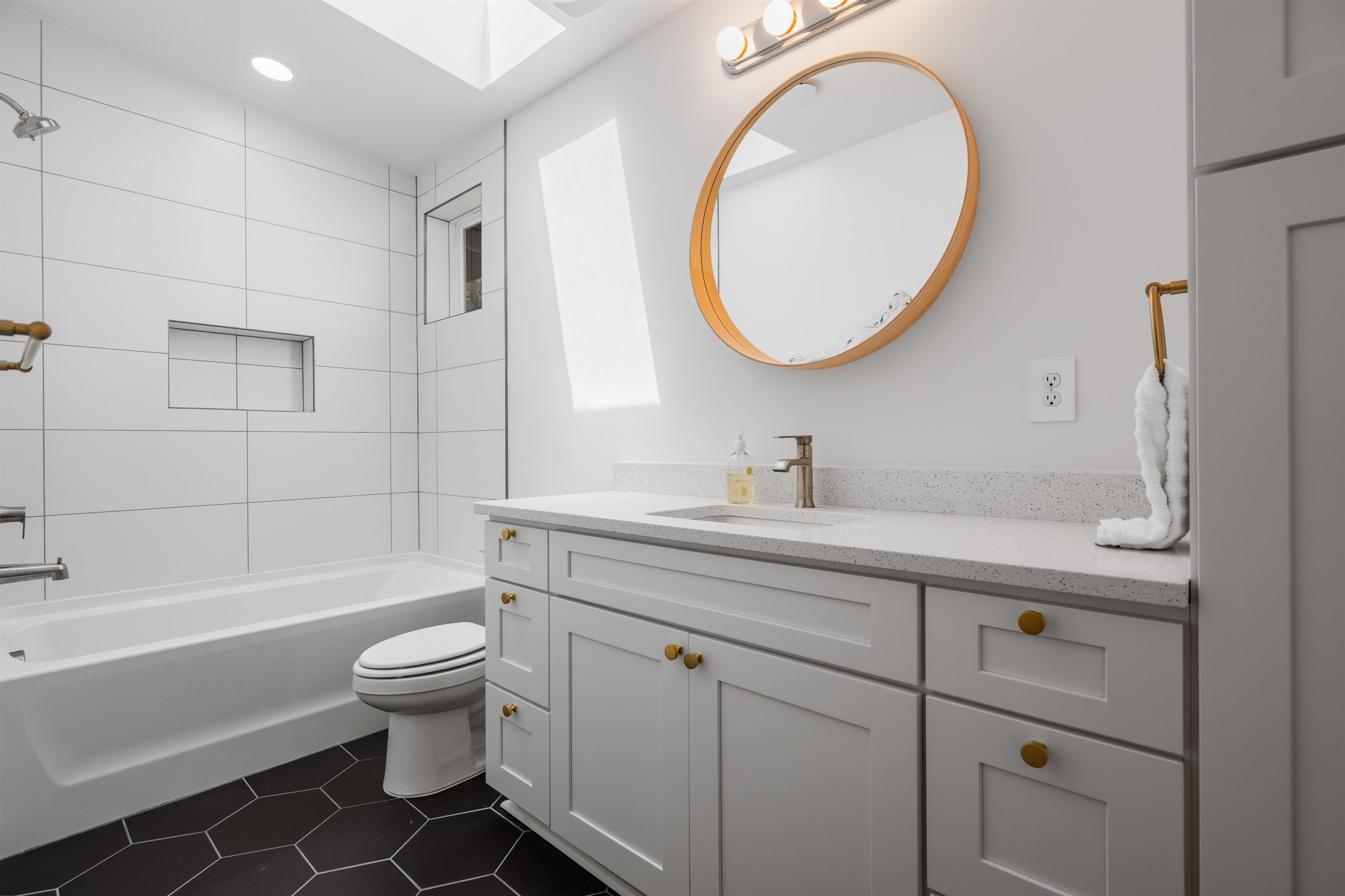 793 Chapin Street St. Augustine, FL 32084 - Photo 15 of 22 Full bathroom featuring shower / bathtub combination, vanity, a skylight, dark tile patterned flooring, and recessed lighting