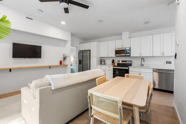 a kitchen with white cabinets and stainless steel appliances