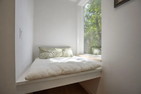 a bedroom with a bed and a window