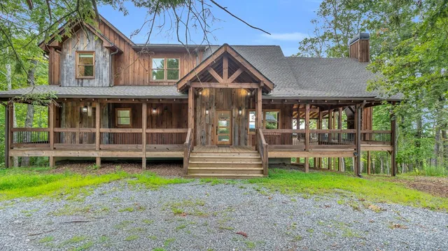a front view of a house with a yard table and chairs
