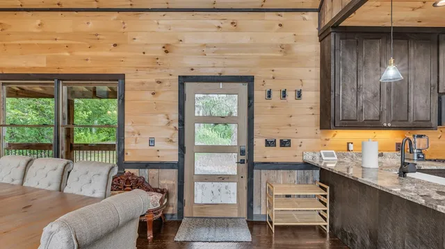 a living room with fireplace furniture and a wooden floor