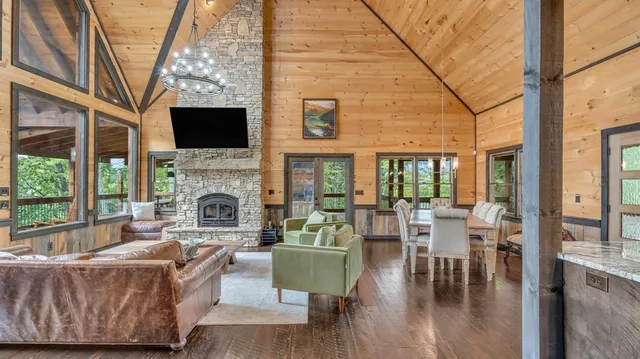a living room with furniture and a floor to ceiling window