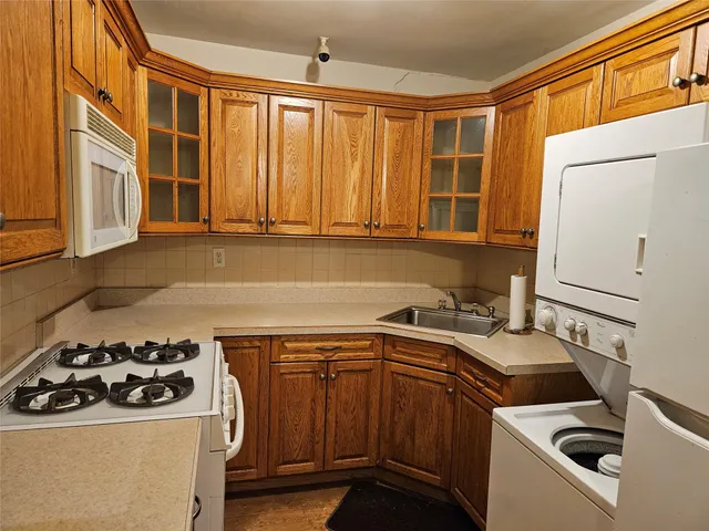 a kitchen with a stove a sink and a microwave