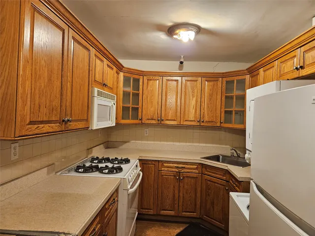 a kitchen with a sink a stove and a refrigerator