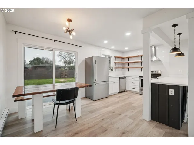 a living room with stainless steel appliances kitchen island granite countertop furniture and a view of kitchen