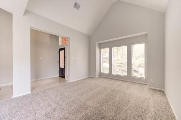 an empty room with windows and closet