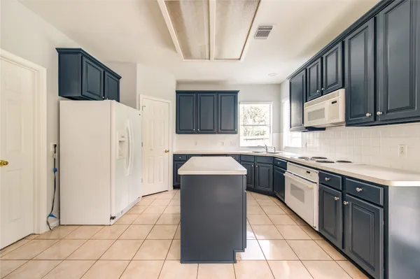 a kitchen with stainless steel appliances cabinets and a counter top space