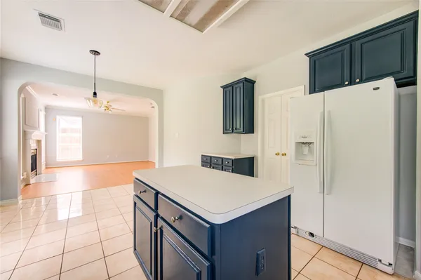 a kitchen with a cabinets and white appliances