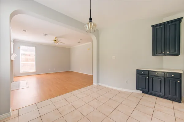 a view of a livingroom with wooden floor and cabinet