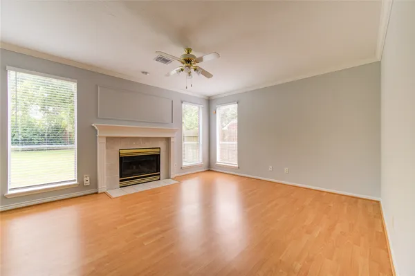 a view of an empty room with a fireplace and a window