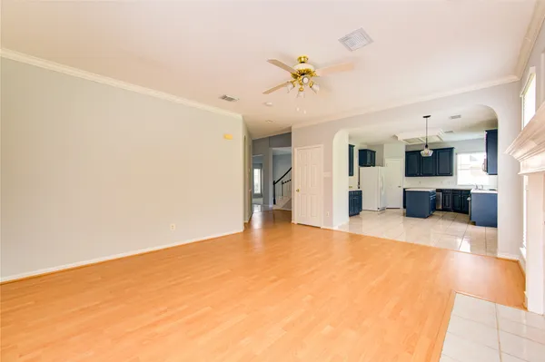 a view of an empty room with a kitchen
